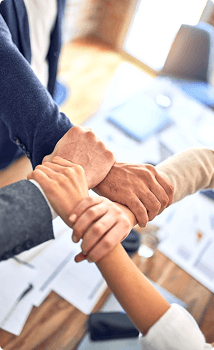 Hands joined in a team huddle
