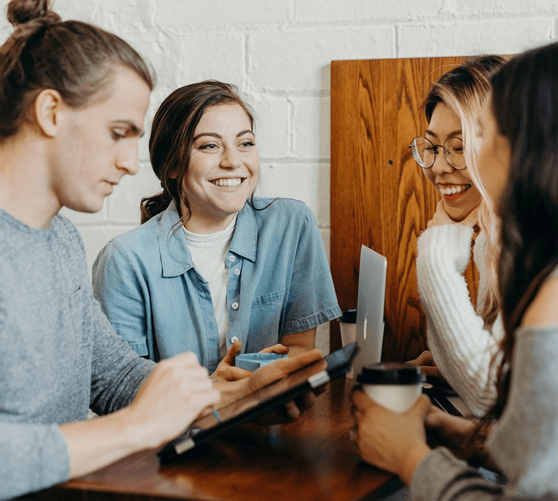 A small team reviewing content together on a laptop